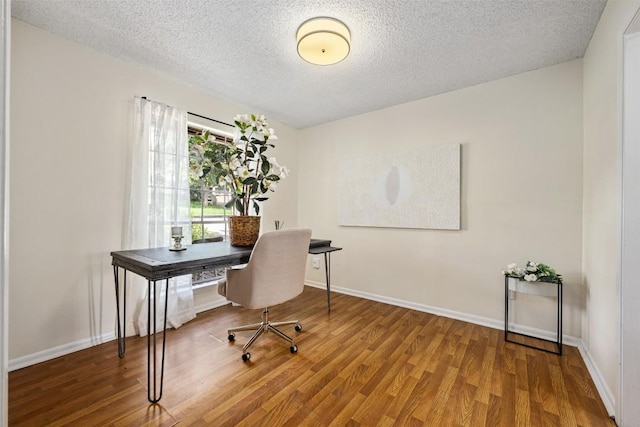 office featuring wood-type flooring and a textured ceiling