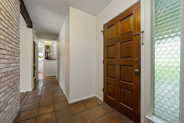 entrance foyer with beam ceiling and a textured ceiling