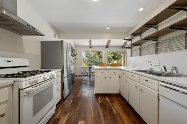 kitchen featuring white appliances, dark wood-type flooring, wall chimney range hood, beam ceiling, and white cabinets