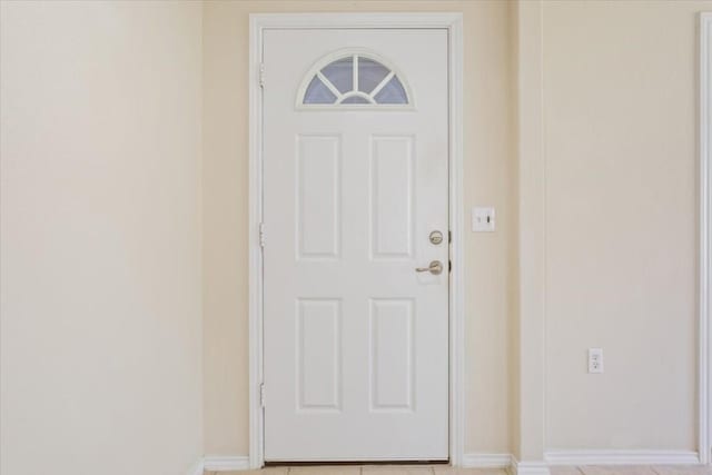 doorway with light tile patterned floors