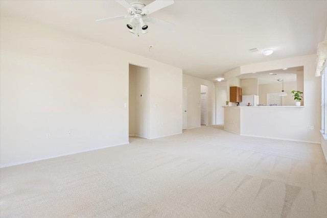 unfurnished living room with ceiling fan and light colored carpet