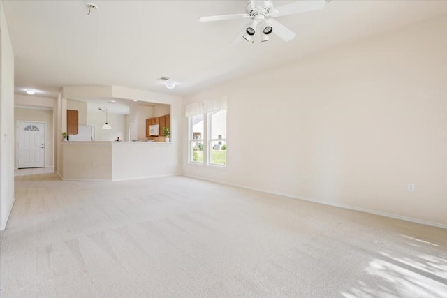 spare room with light carpet and ceiling fan