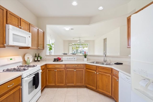 kitchen with light tile patterned floors, white appliances, ceiling fan, and sink