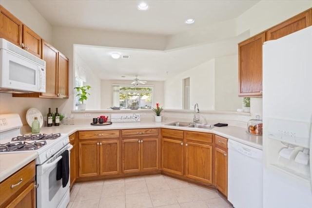 kitchen featuring kitchen peninsula, white appliances, ceiling fan, sink, and light tile patterned floors