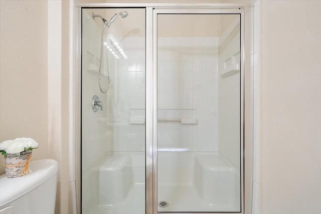 bathroom with toilet and walk in shower