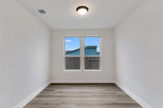 unfurnished room with light wood-type flooring