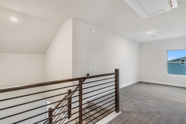 interior space featuring vaulted ceiling and carpet flooring