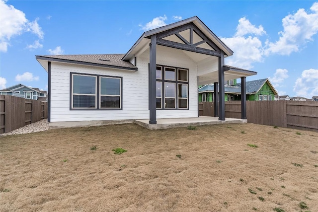 back of house featuring a yard and a patio area