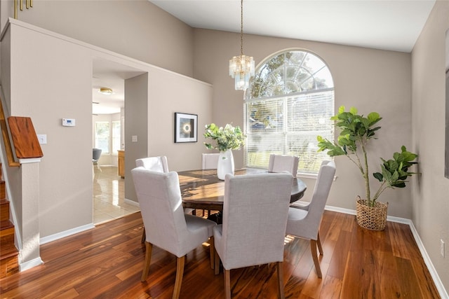 dining area with hardwood / wood-style flooring and a chandelier