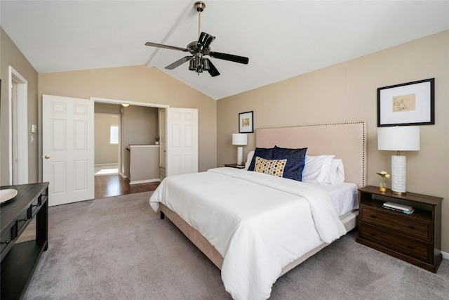 bedroom featuring ceiling fan, light colored carpet, and vaulted ceiling