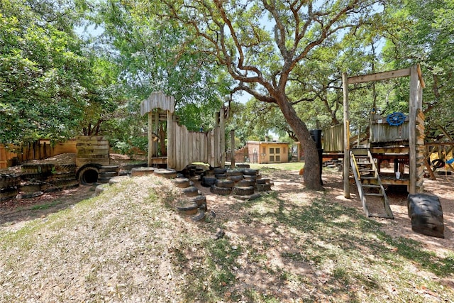 view of yard with a playground and a storage shed