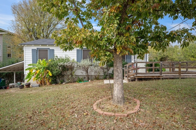 view of yard with a wooden deck and a carport