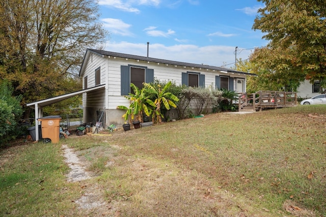 exterior space with a yard and a wooden deck