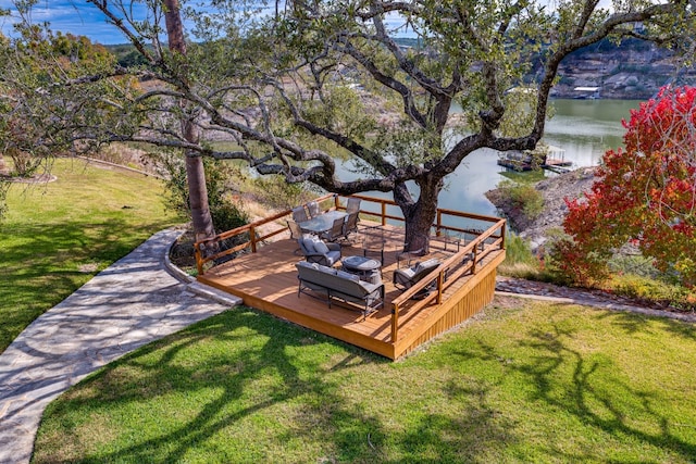 exterior space featuring a lawn and a water view