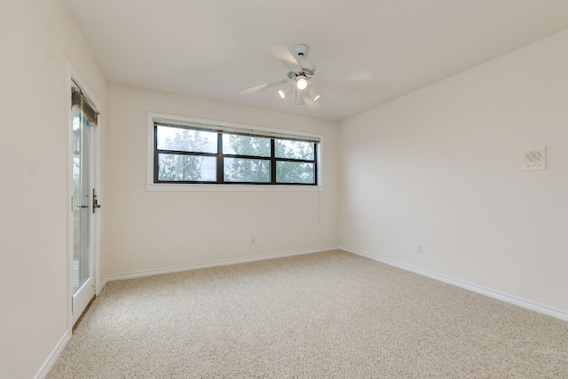 carpeted spare room with ceiling fan