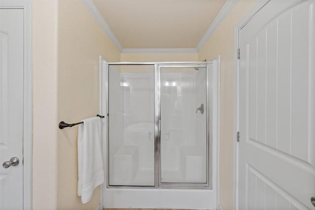 bathroom featuring a shower stall and ornamental molding