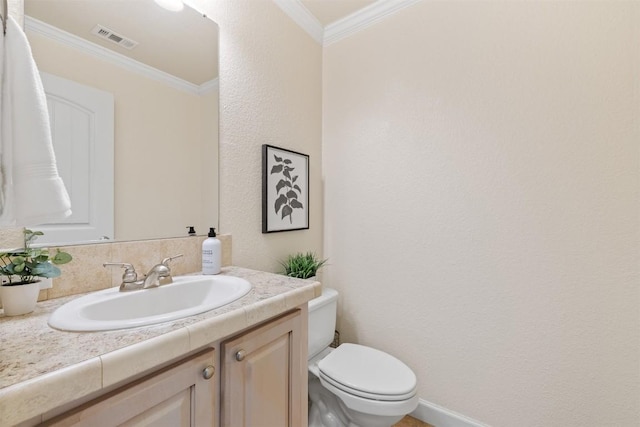 bathroom with ornamental molding, visible vents, vanity, and toilet