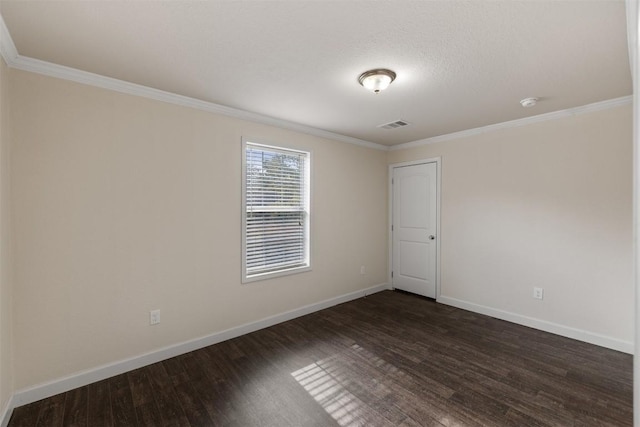 unfurnished room with ornamental molding, dark wood-type flooring, visible vents, and baseboards