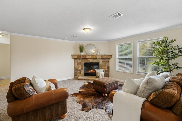 carpeted living room featuring baseboards, visible vents, a stone fireplace, crown molding, and a textured ceiling