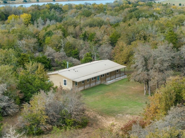 drone / aerial view with a water view and a forest view