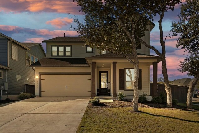 view of front of property with a lawn and a garage