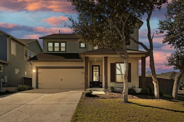 traditional-style house featuring driveway, a garage, and fence