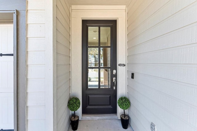 property entrance featuring concrete block siding