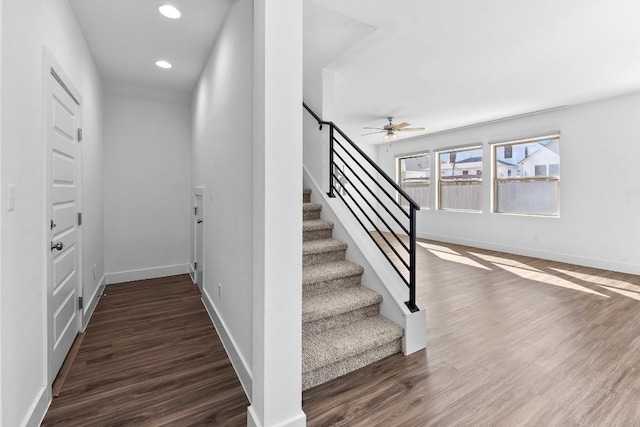 stairs featuring recessed lighting, wood finished floors, a ceiling fan, and baseboards