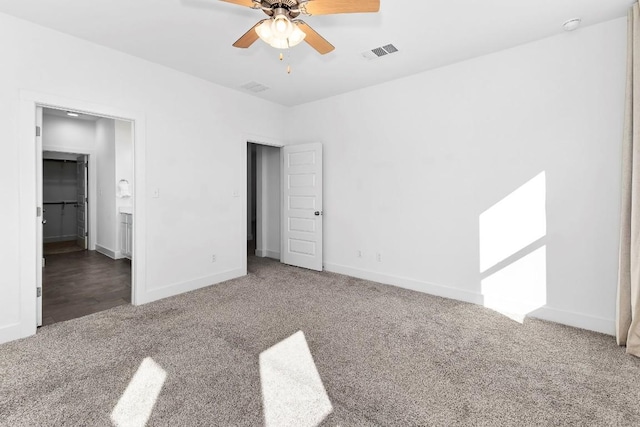 unfurnished bedroom featuring a ceiling fan, baseboards, visible vents, and carpet flooring