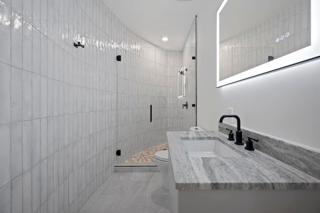 bathroom with vanity, an enclosed shower, and toilet