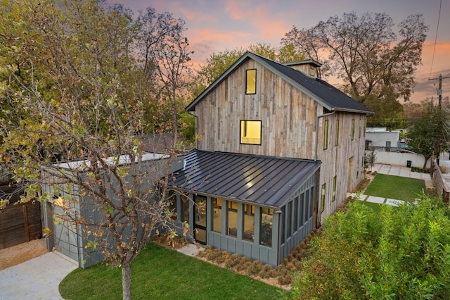 back house at dusk with a yard