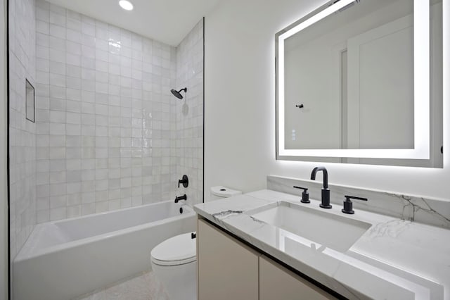 full bathroom with vanity, toilet, and tiled shower / bath combo