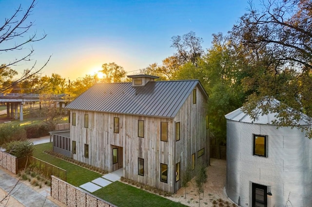 outdoor structure at dusk with a lawn