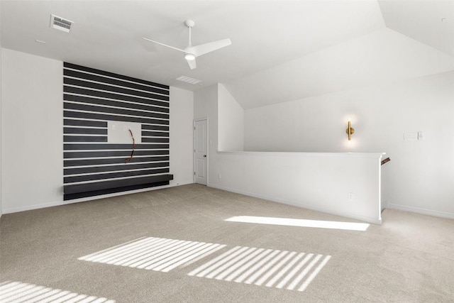 additional living space featuring light carpet, ceiling fan, and vaulted ceiling