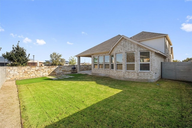 rear view of house with a lawn