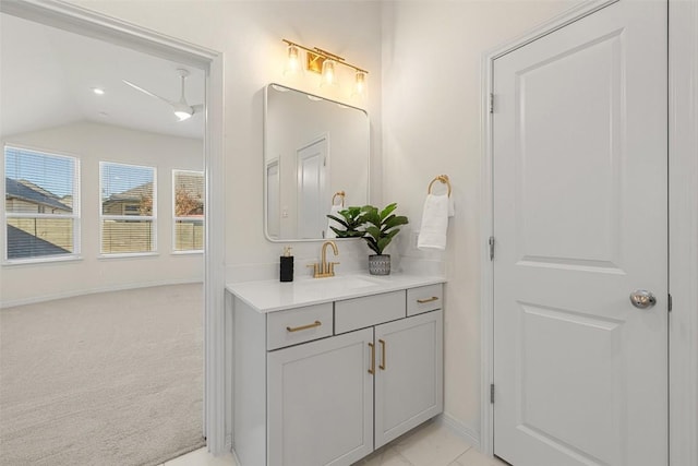 bathroom featuring vaulted ceiling and vanity