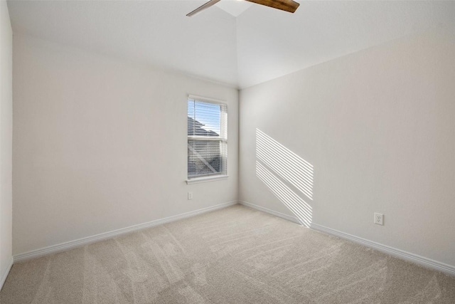 carpeted spare room with lofted ceiling and ceiling fan