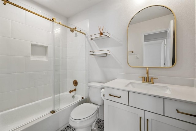 full bathroom with bath / shower combo with glass door, vanity, and toilet