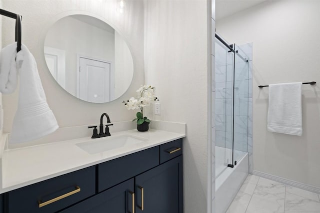 bathroom featuring combined bath / shower with glass door and vanity