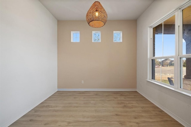 empty room with light hardwood / wood-style flooring