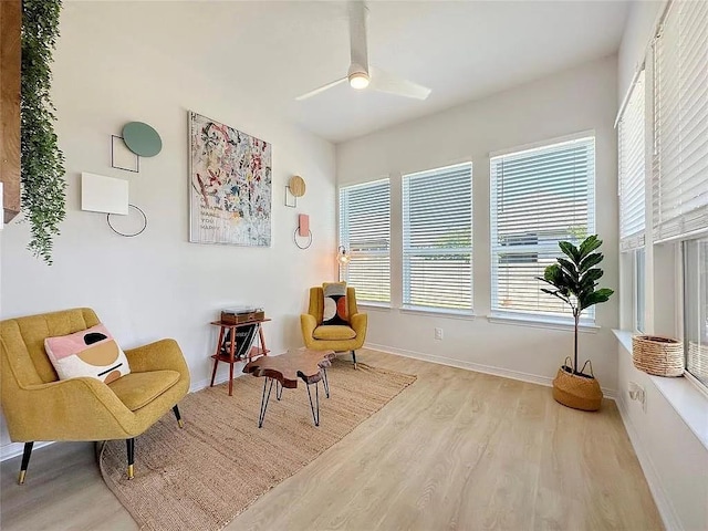 sitting room with light hardwood / wood-style floors and ceiling fan