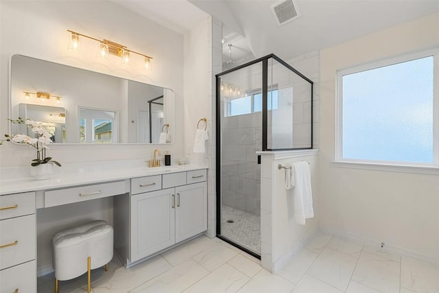 bathroom with a shower with door and vanity