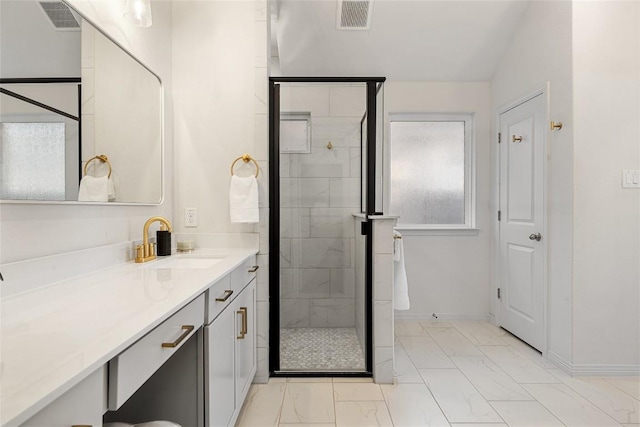 bathroom with walk in shower and vanity