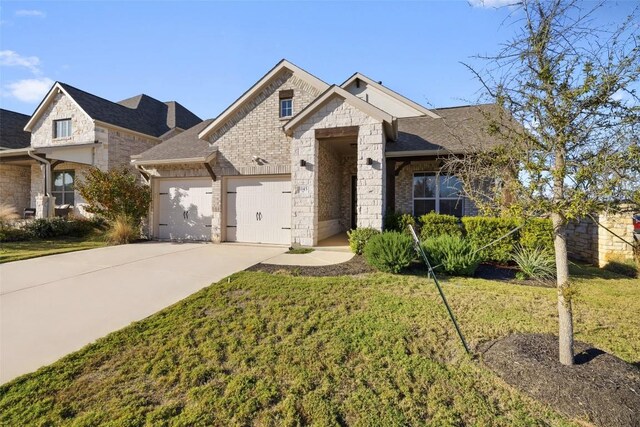 view of front of home with a front yard and a garage