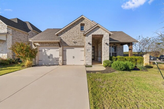 view of front of home featuring a front lawn and a garage