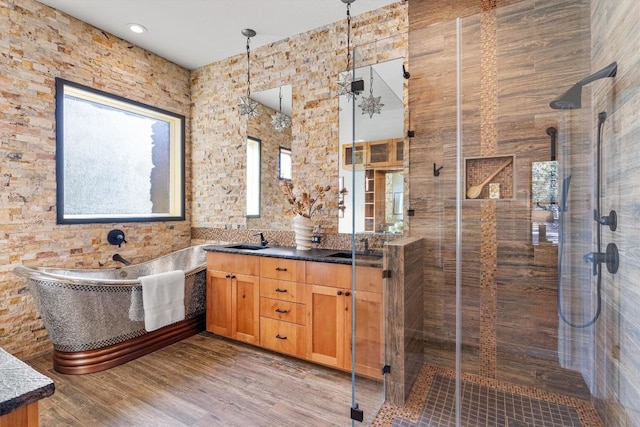 bathroom with shower with separate bathtub, vanity, and hardwood / wood-style floors