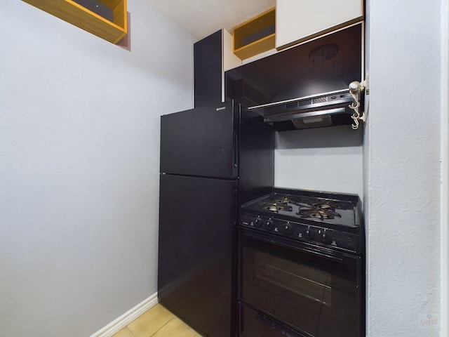 kitchen featuring light tile patterned floors, black appliances, and range hood