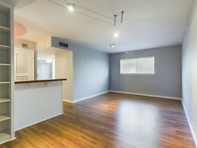 unfurnished living room featuring dark hardwood / wood-style floors