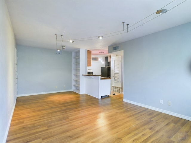 unfurnished living room featuring light wood-type flooring