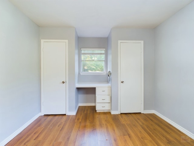 unfurnished bedroom featuring hardwood / wood-style floors